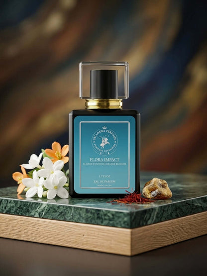 Perfume bottle with flowers and a rock on a marble surface