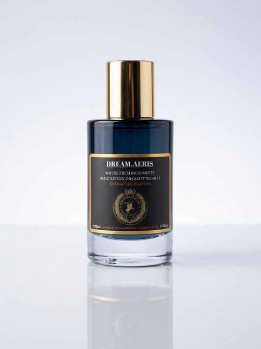 A bottle of Dream Aerus Night Freshen Scent with a dark navy blue glass body, a shiny gold cap, and a black label with gold detailing, set against a clean white background with a soft reflection.