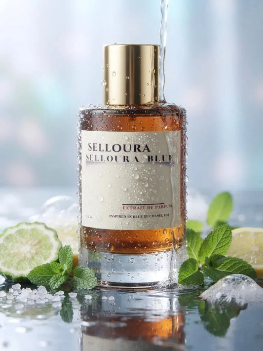 A bottle of SELLOURA SELLOURA BLUE Eau de Parfum with amber liquid, a gold cap, and a cream label, surrounded by ice, mint, and lime slices with water droplets and a stream of water running into it.